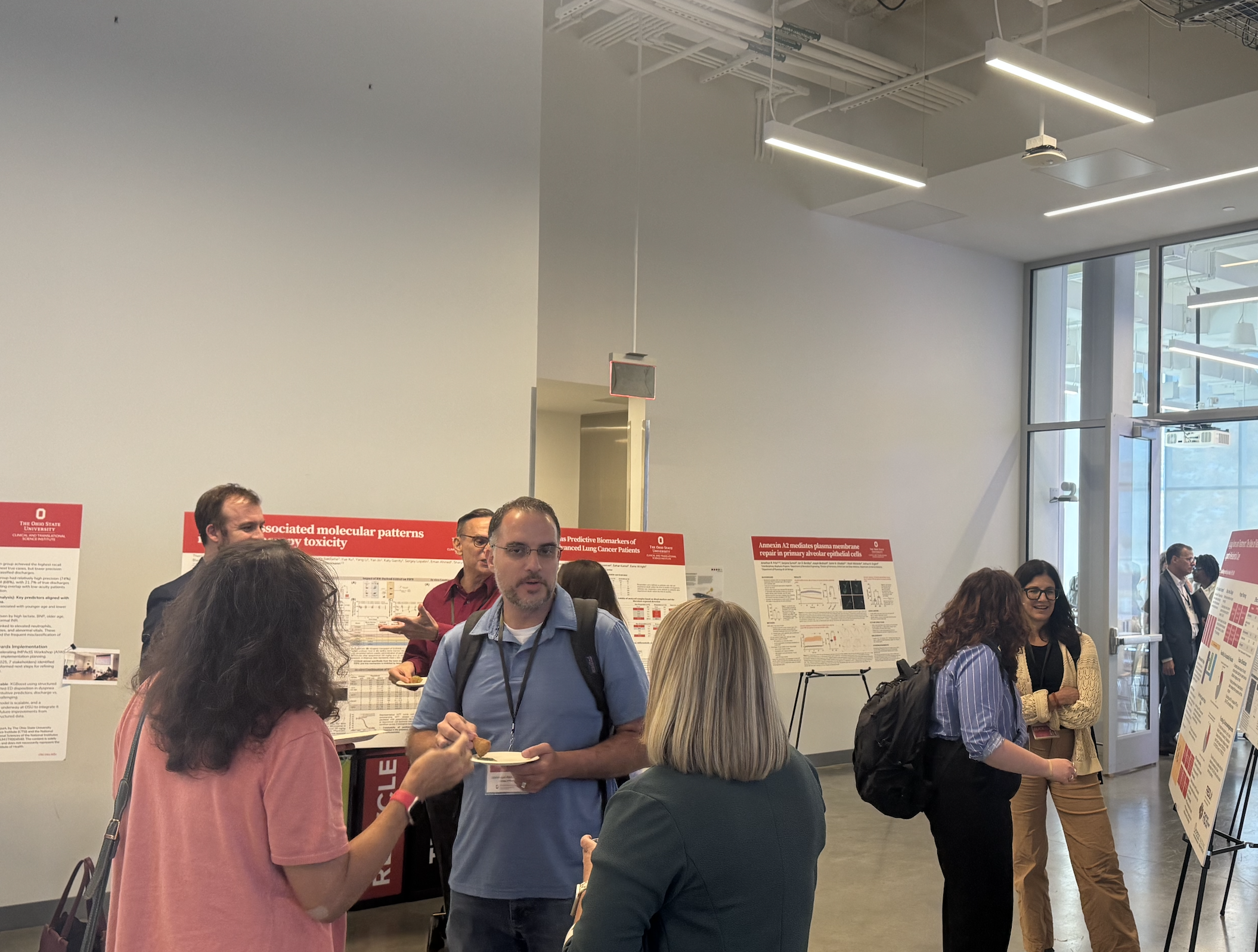 group of people talking at poster session