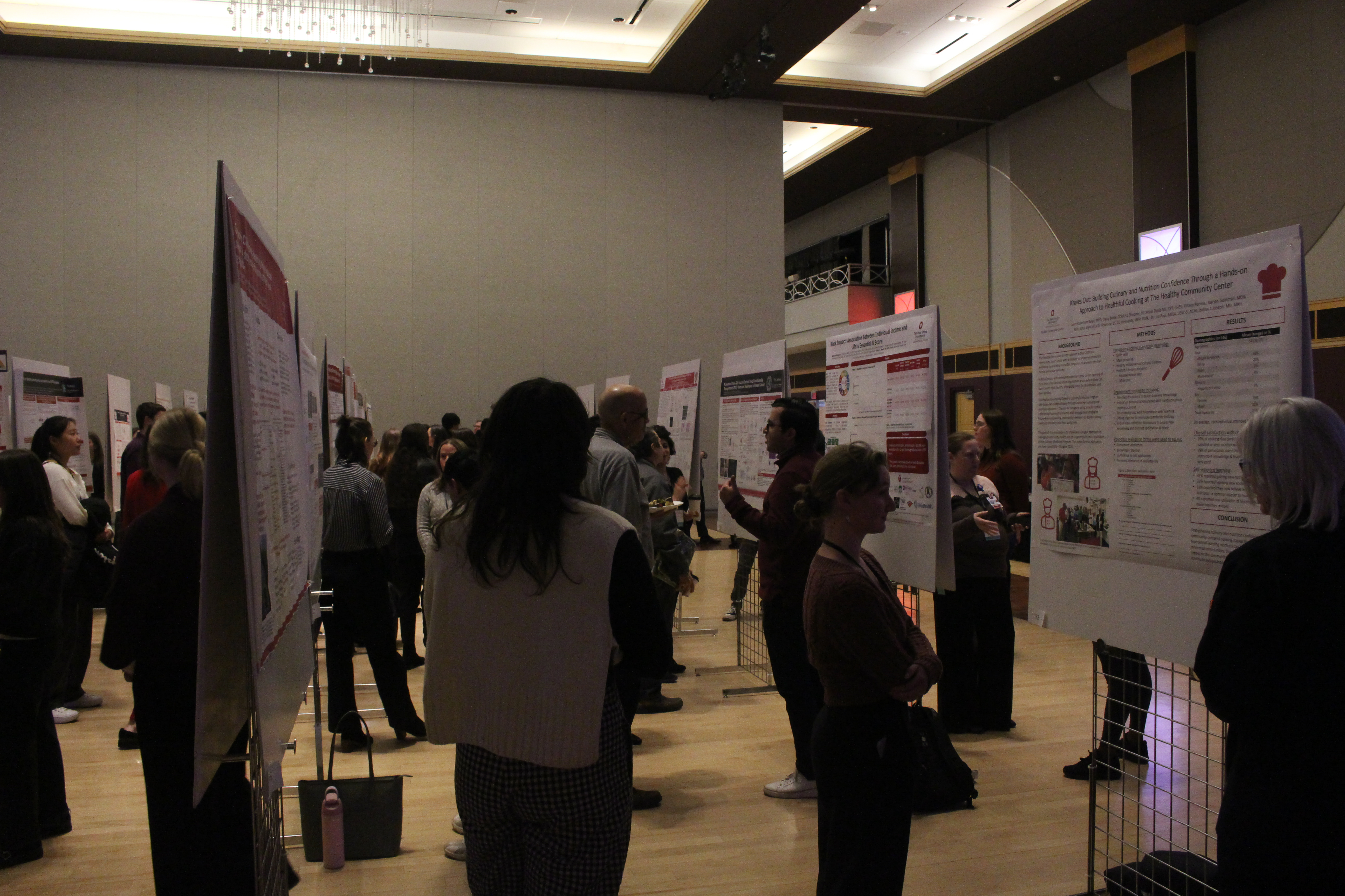 Individuals interacting with posters at scientific meeting