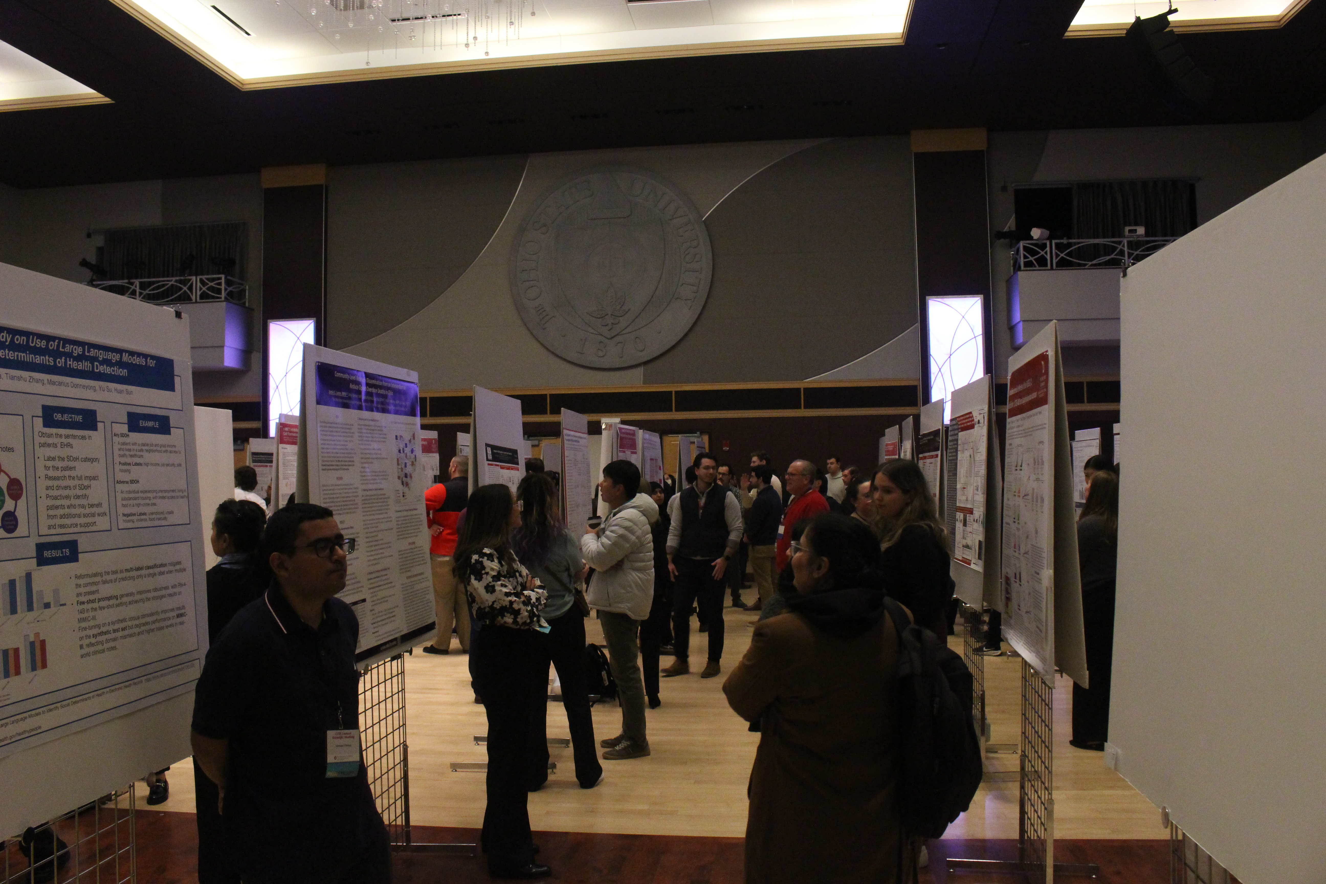 Individuals interacting with each other at a scientific poster session