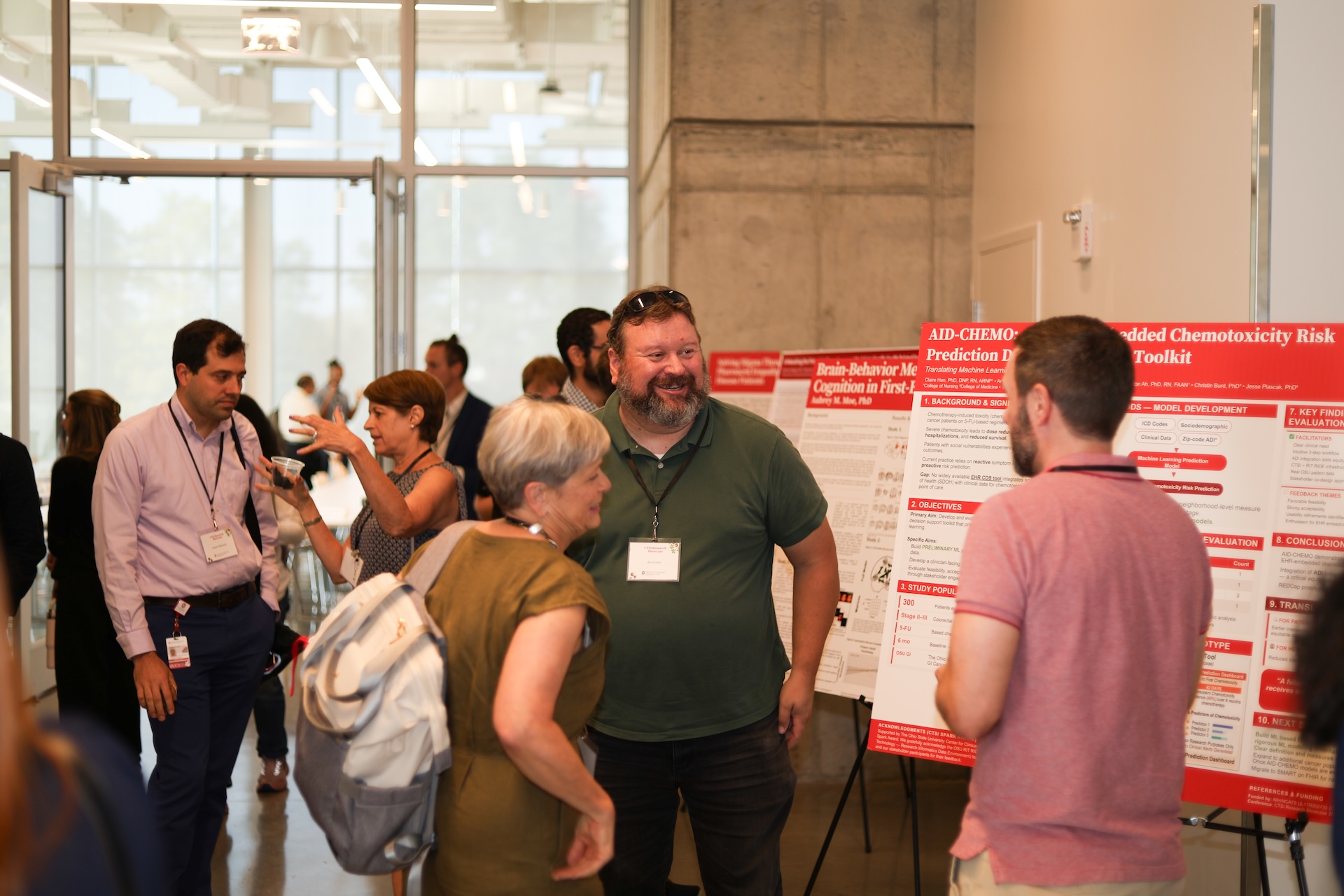 Attendees engaging in conversation during the poster session