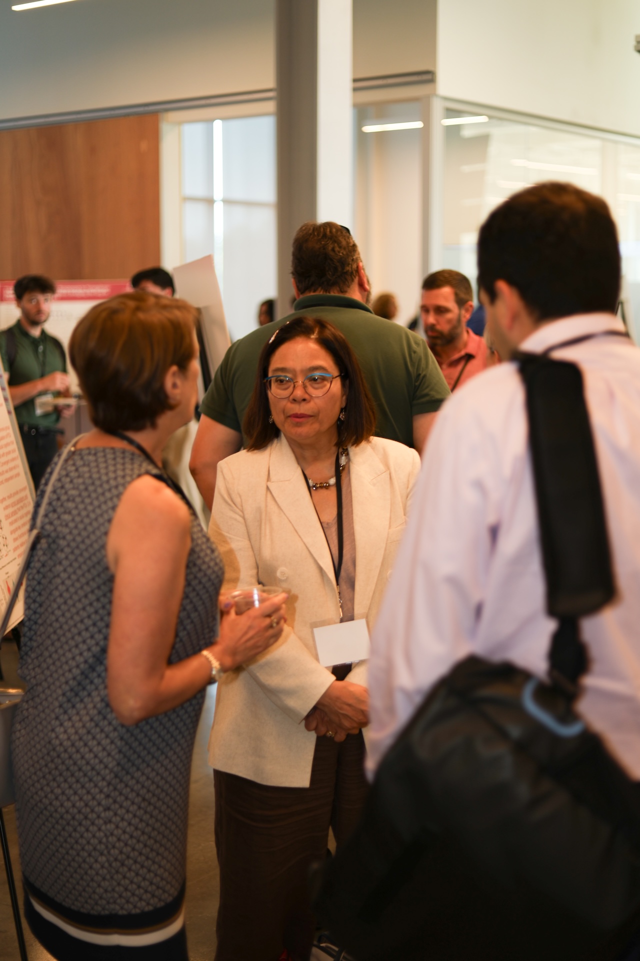 Attendees and presenters interacting during poster session