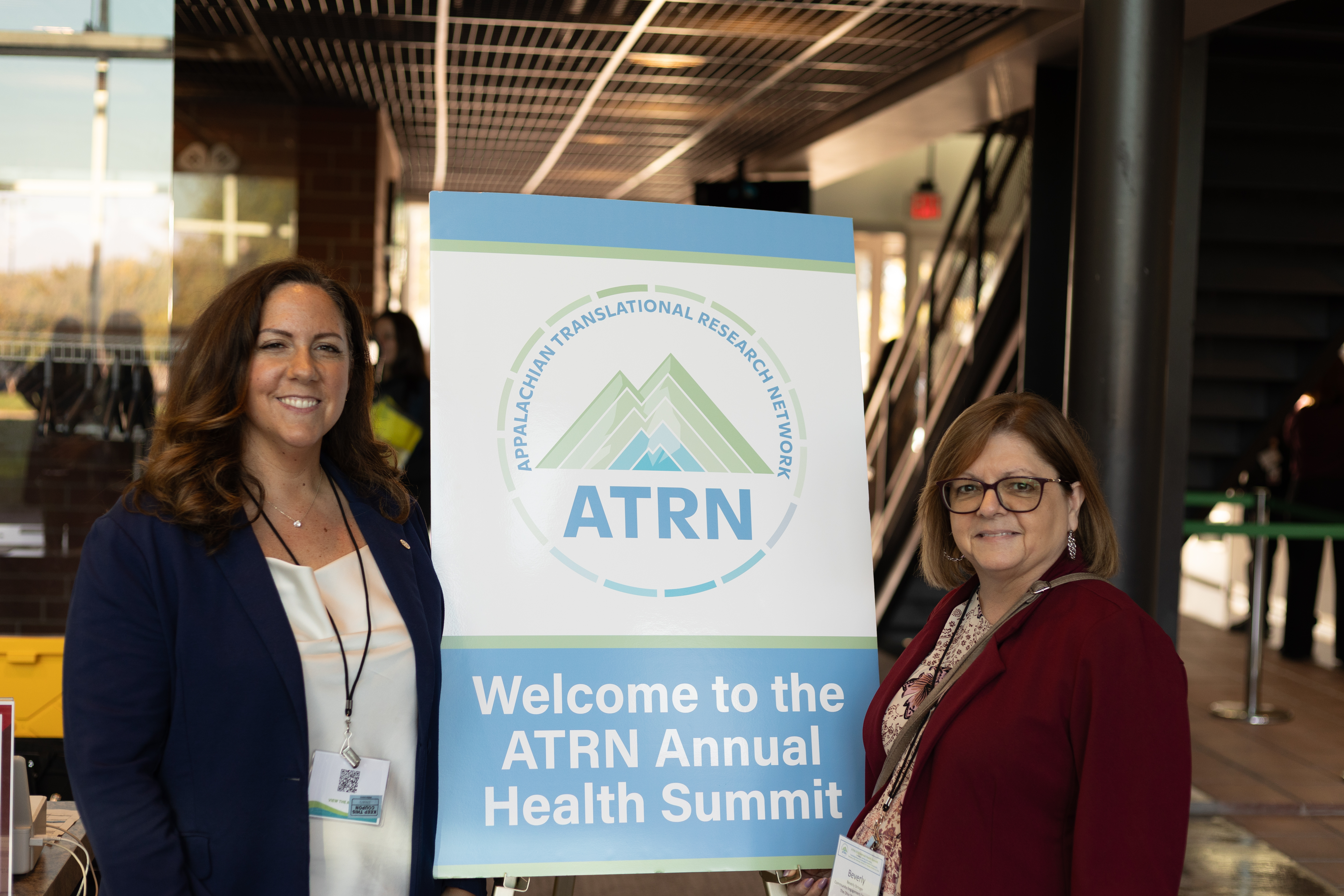 Halea Hatten and beverly Stinger in front of ATRN sign
