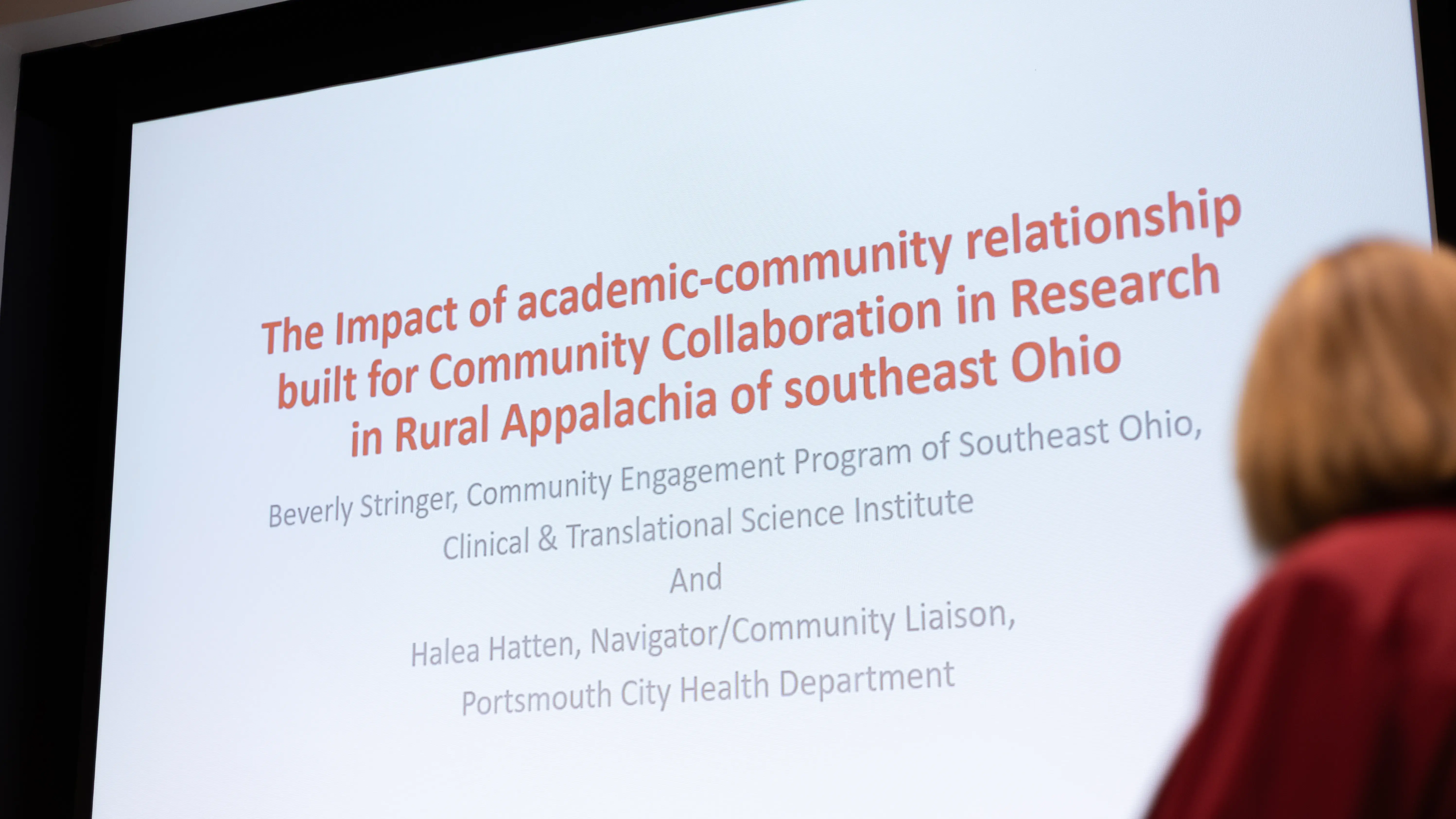 Projector screen with the following wording: The impact of academic-community relationship built for community collaboration in research in rural appalachia of southeast ohio