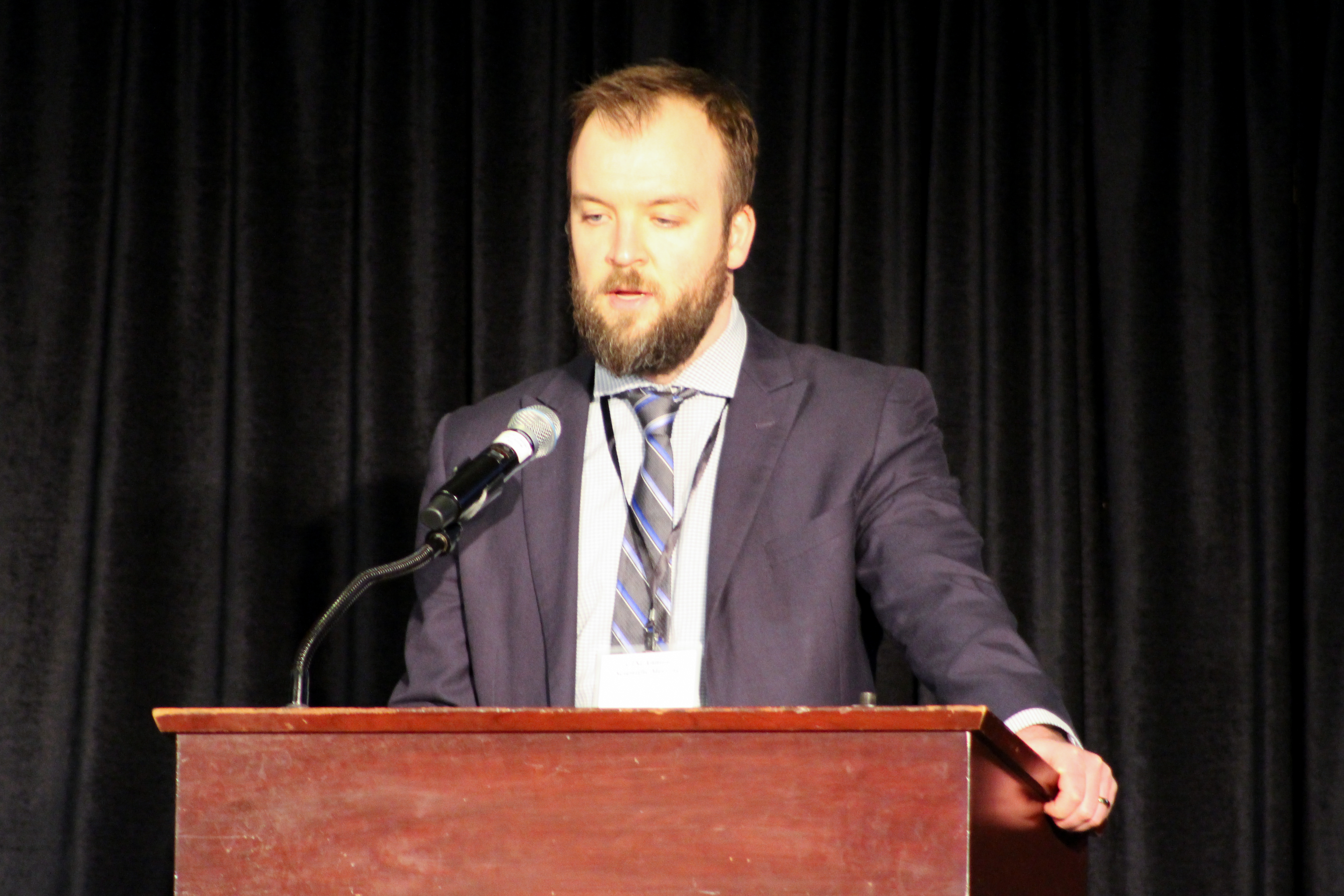 Eric Eisenmann speaking at a podium