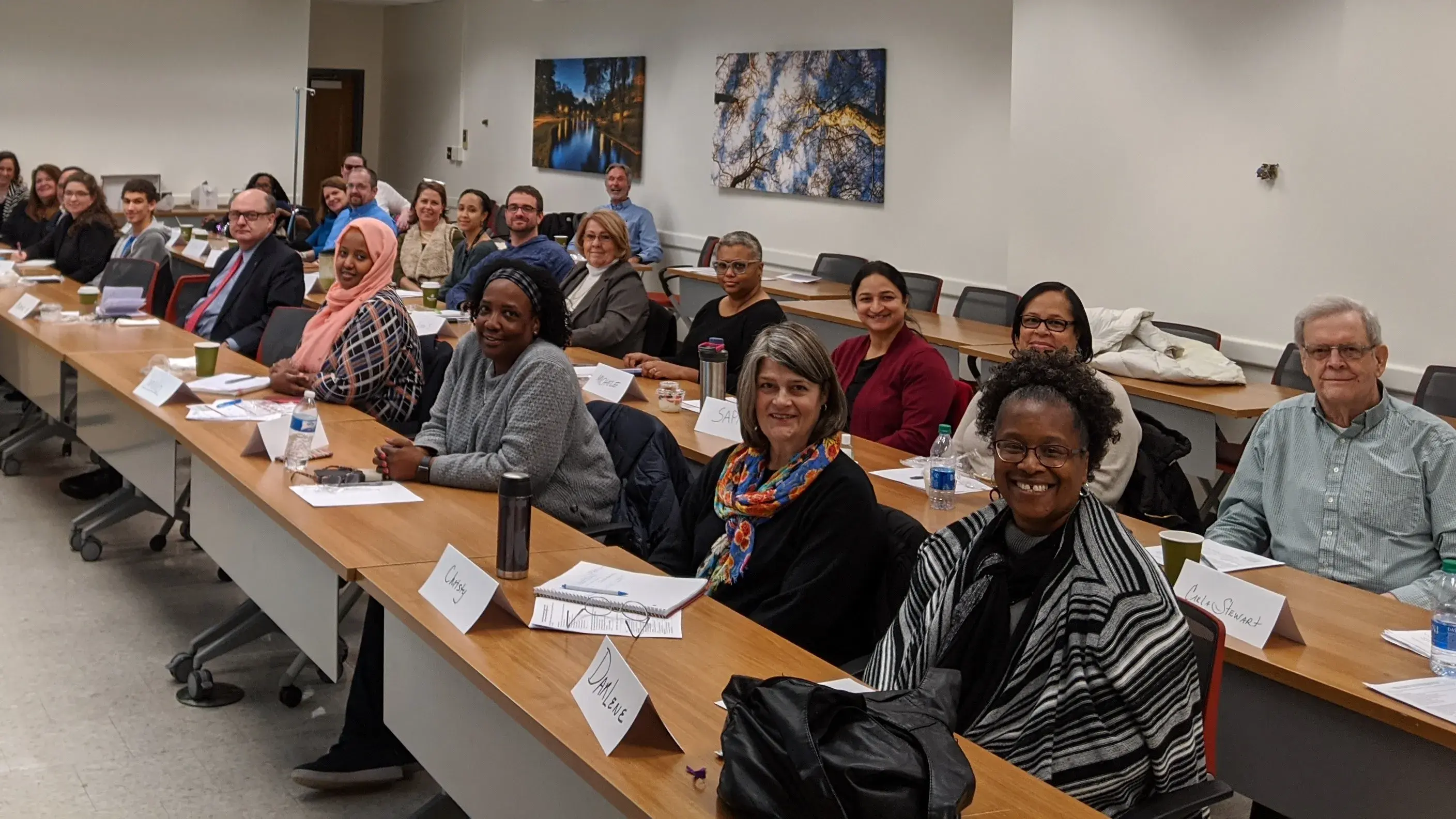 large group on people sitting in long rows of desks in a classroom setting