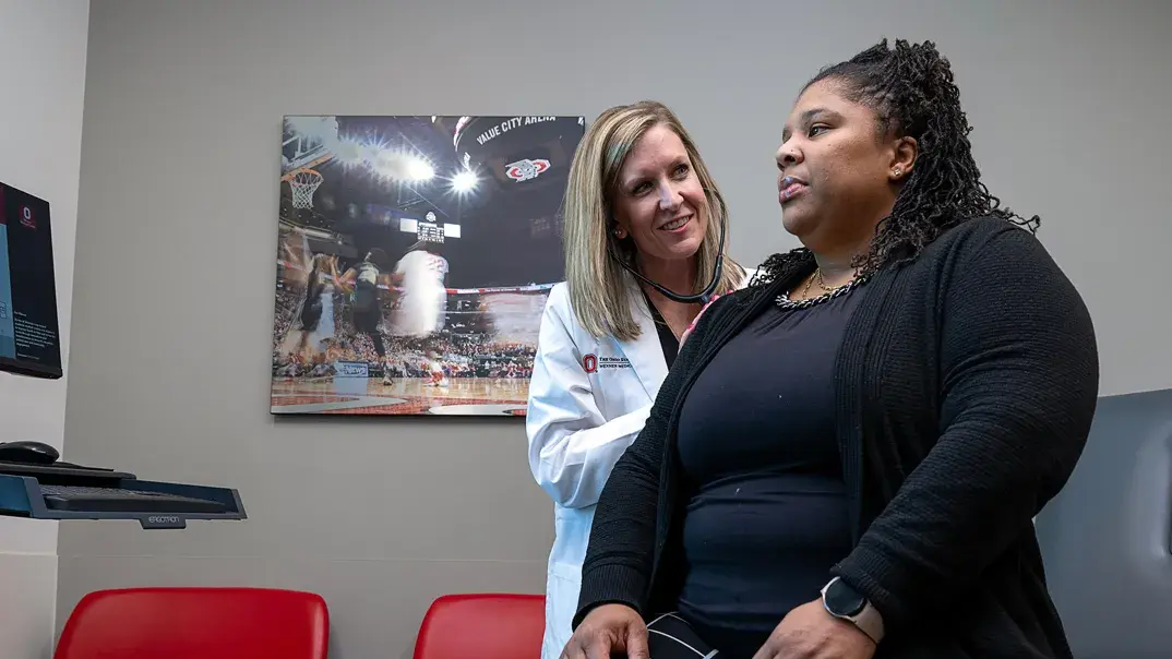 female medical professional checking up with a patient in an office setting