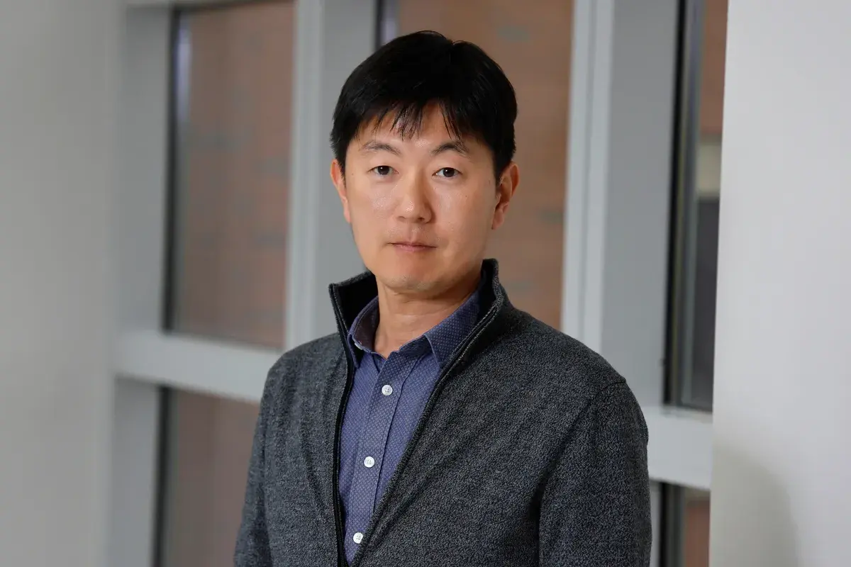 portrait of Sangwoon Chung wearing a gray sweater