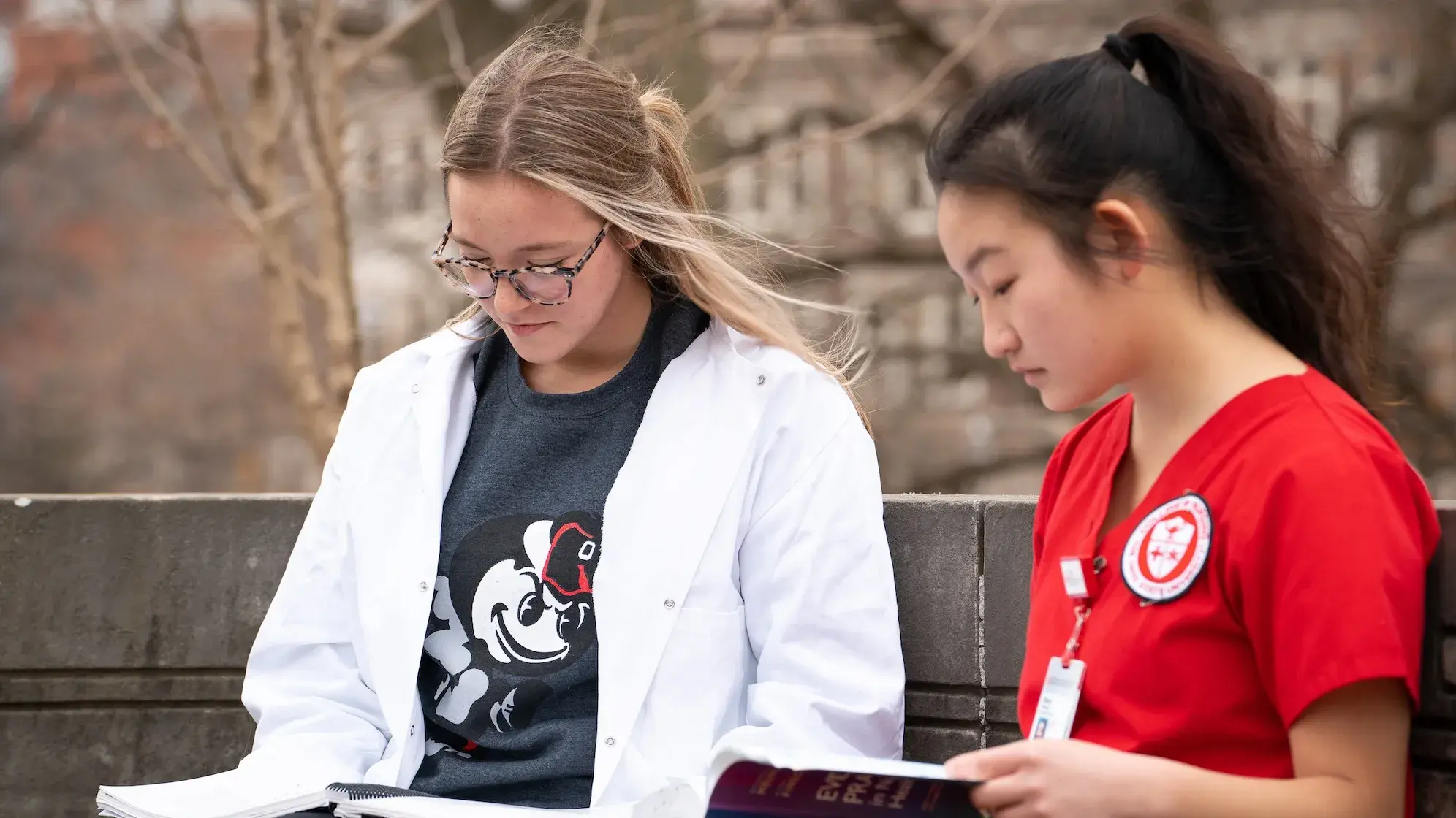 Two nursing students studying outside