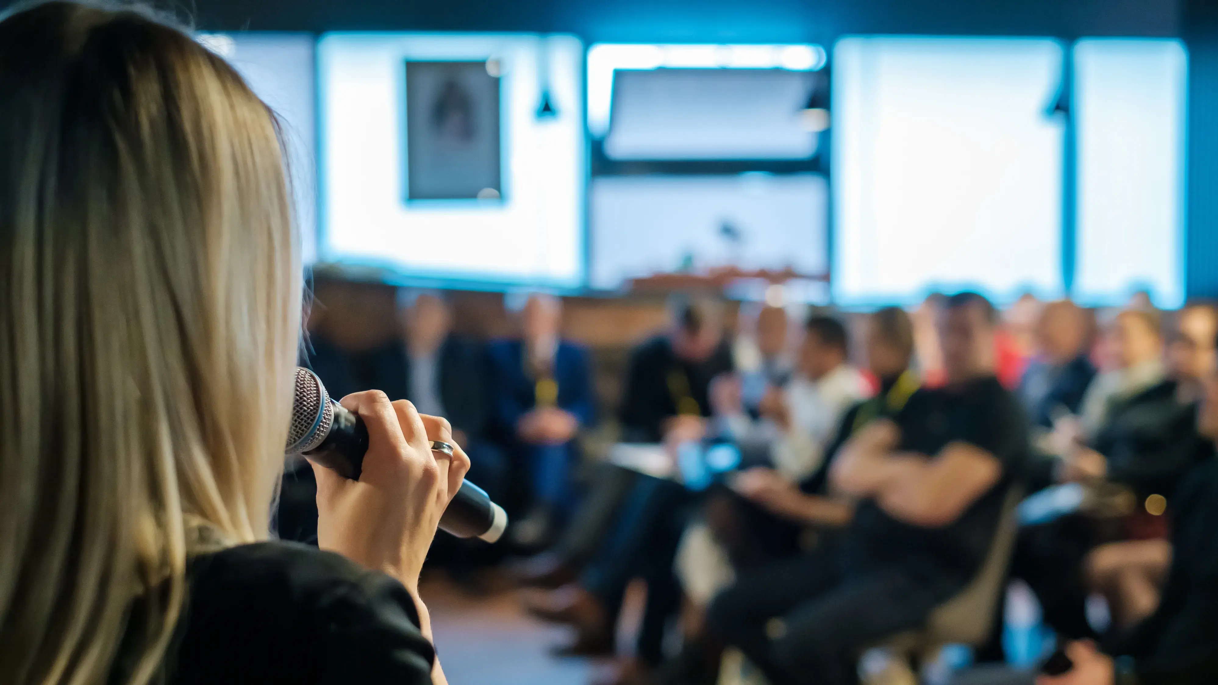 Woman giving presentation to crowd