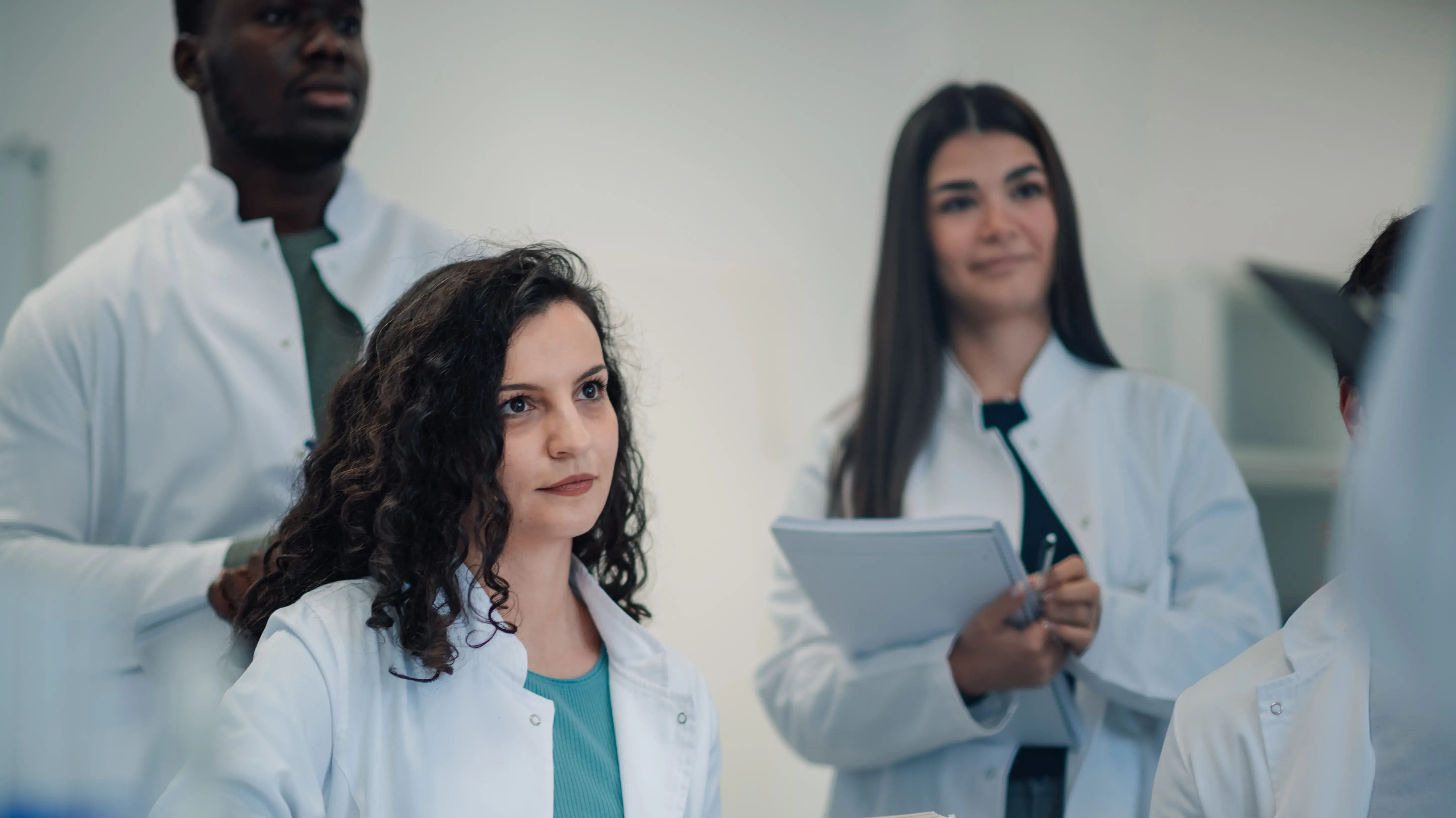 Three Llearners in white coats