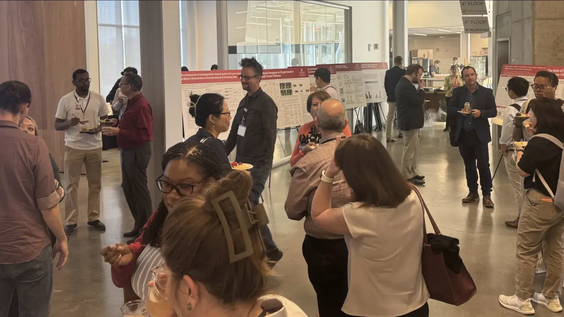 researchers talking by posters