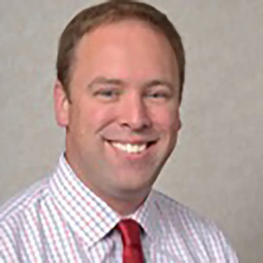 portrait of Jeff Grever wearing a red tie smiling for the camera